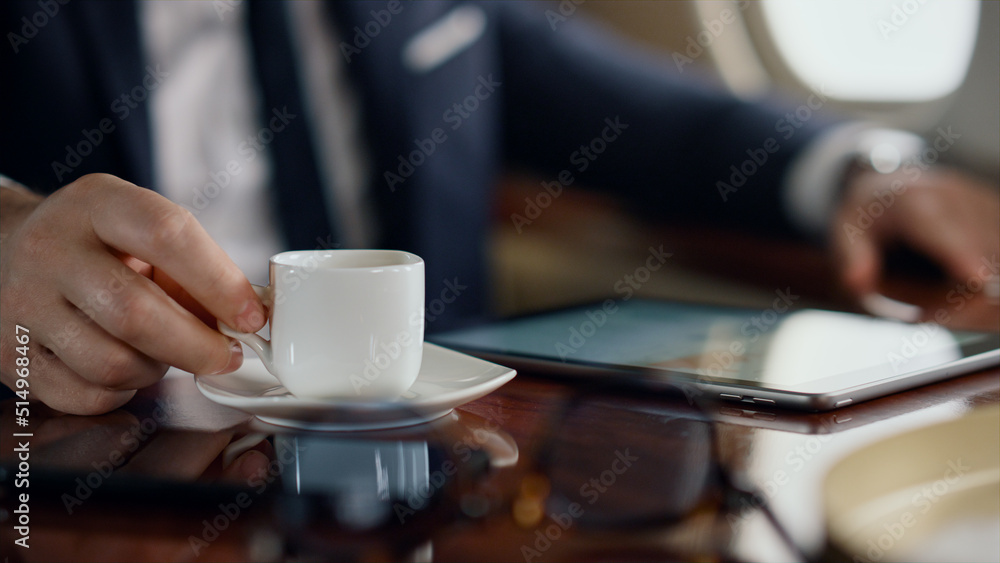 Man enjoying coffee beverage on business trip. Closeup hand taking tea cup
