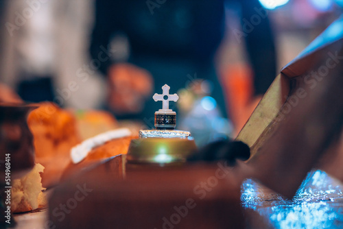 Ornament with a cross on a table prepared for a baby's christening baptism in a church. High quality photo photo