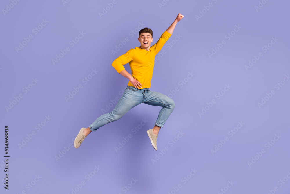 Full body profile side photo of young man jump up fly protection power superhero isolated over violet color background
