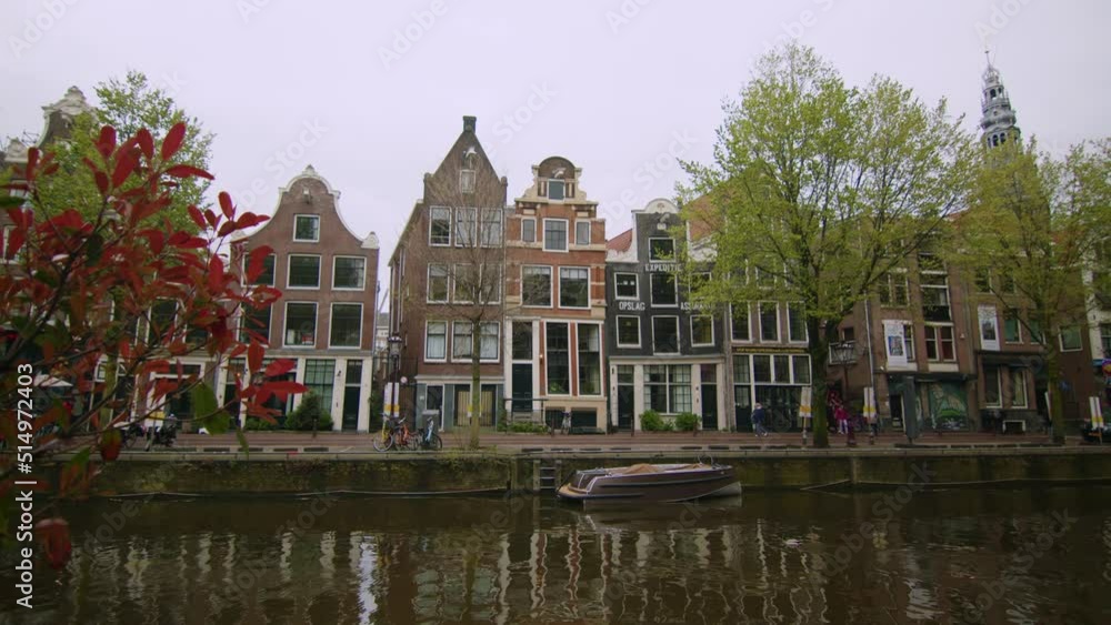 Amsterdam Canal and houses with historical facade architecture, wide angle static shot, Old city Netherlands Amsterdam Canal and houses with historical facade architecture, wide angle static shot, Old city Netherlands