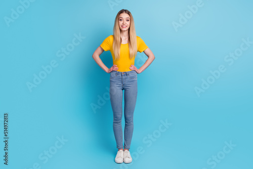 Full length portrait of pretty woman isolated on blue background
