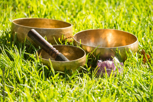 Still life with Tibetan bowls on grass.