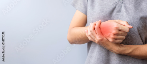 woman holding her wrist pain because using smartphone or computer long time. De Quervain s tenosynovitis, Intersection Symptom, Carpal Tunnel Syndrome or Office syndrome concept photo