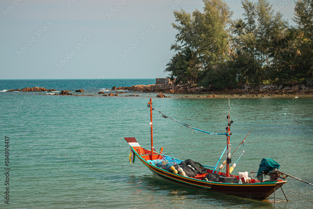 Koh Phangan, Thailand - December 23rd, 2019 : long-tail boat docked in the north of Koh Phangan with on sunny day in the Gulf of Thailand