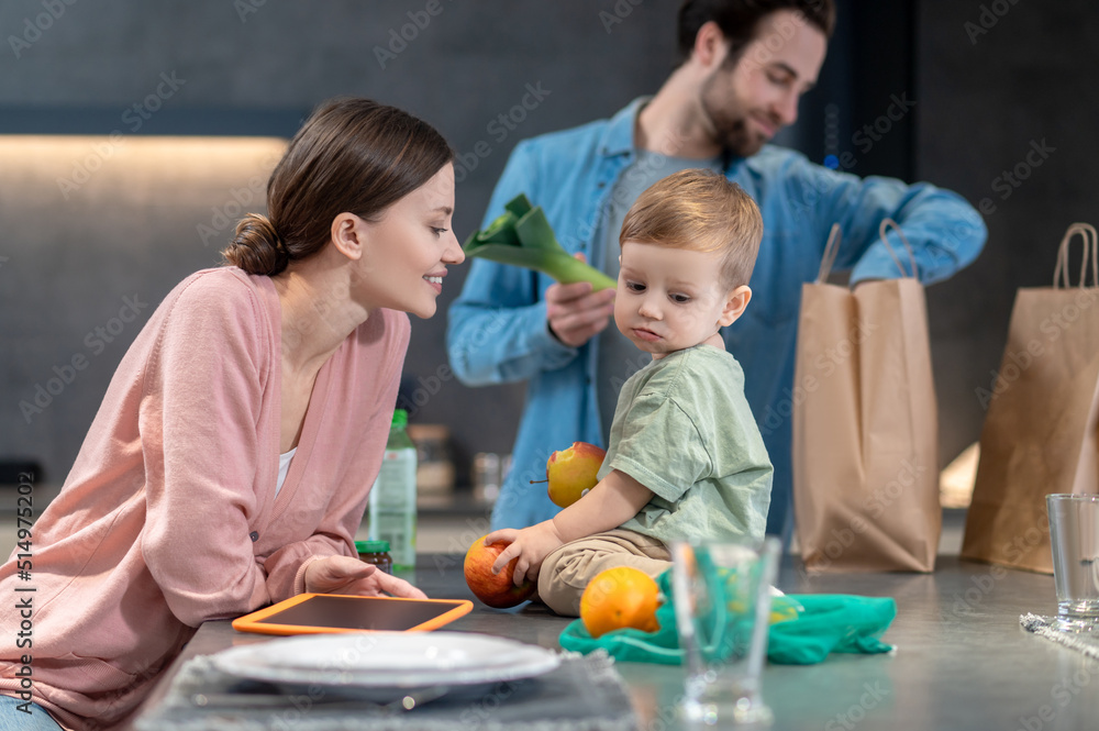 Obraz premium Young happy family preparing to have a healthy lunch