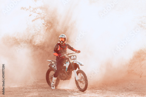 Fototapeta Naklejka Na Ścianę i Meble -  Live shot of male sportsman training on motorbike at hot summer day, outdoors. Motocross rider in action. Motocross sport