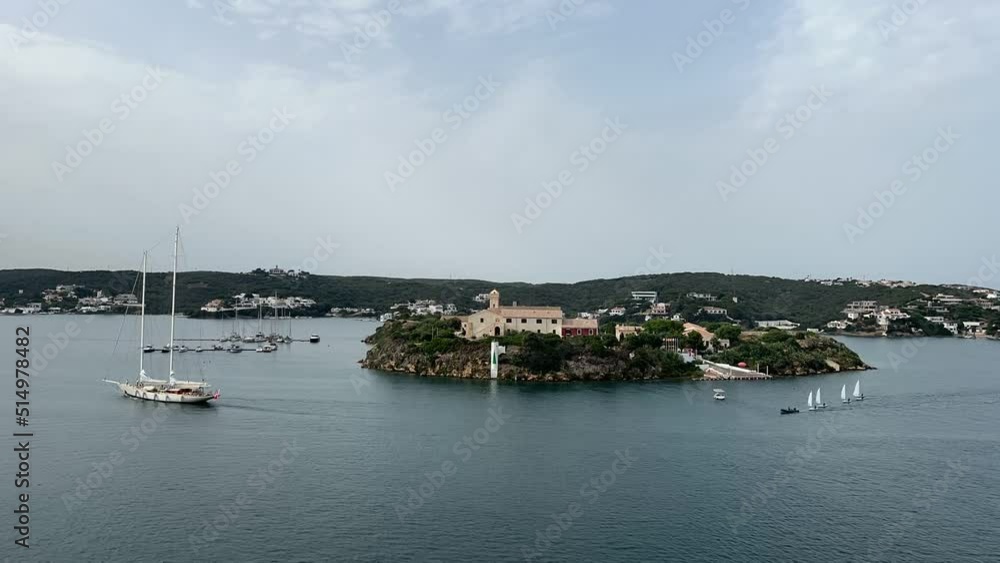 Timelapse of the King’s island, in Menorca, Spain, a great natural bay, with many sailboats, in a race in a cloudy day Timelapse of the King’s island, in Menorca, Spain, a great natural bay, with many sailboats, in a race in a cloudy day