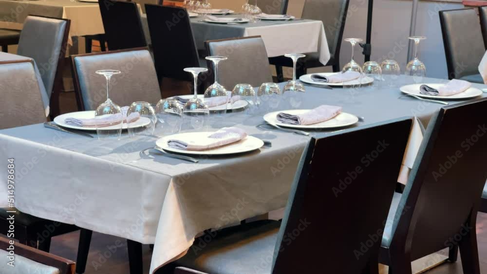 Restaurant dining room with well-dressed tables with leather chairs Restaurant dining room with well-dressed tables with leather chairs