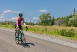 woman cycling on gravel road