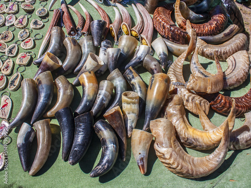 Souvenir horns for sale on a green background