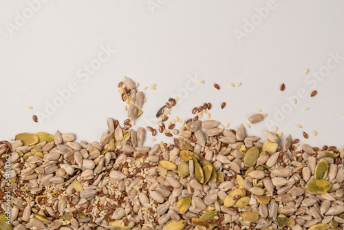 Mix of seeds for a salad. A pile of mixed seeds isolated on white background. © Nikolay