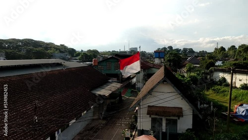 red and white flag flying on pole in front of government office, bendera merah putih nasional indonesia photo