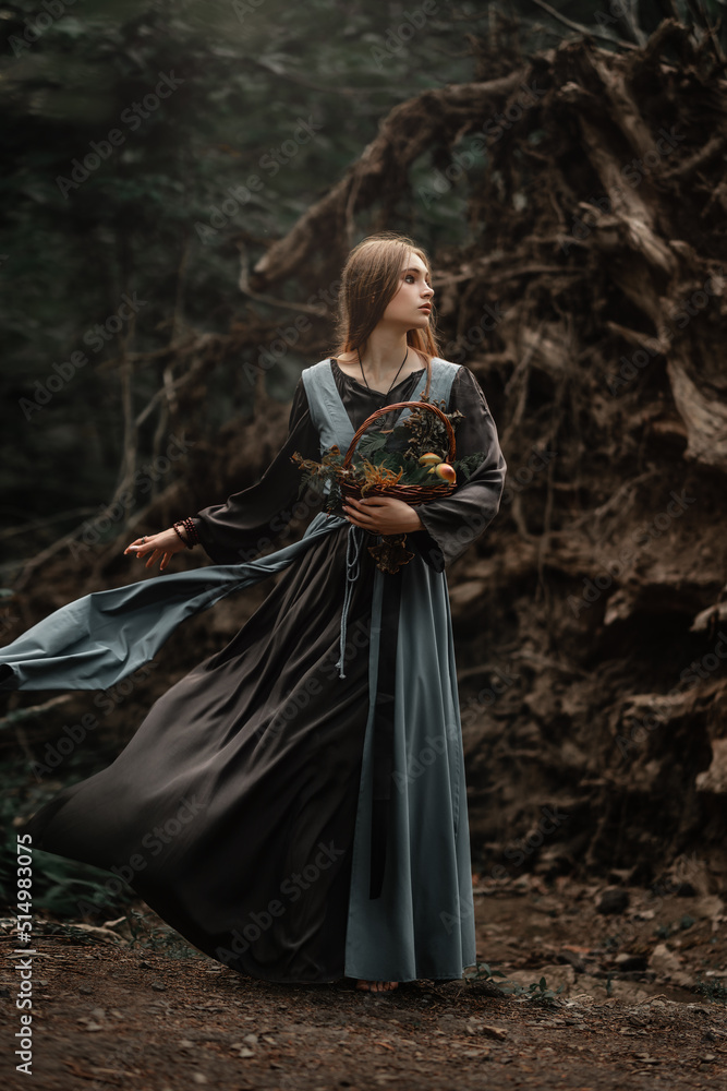 A mysterious witch walks in a dark forest A mysterious witch walks in a dark forest