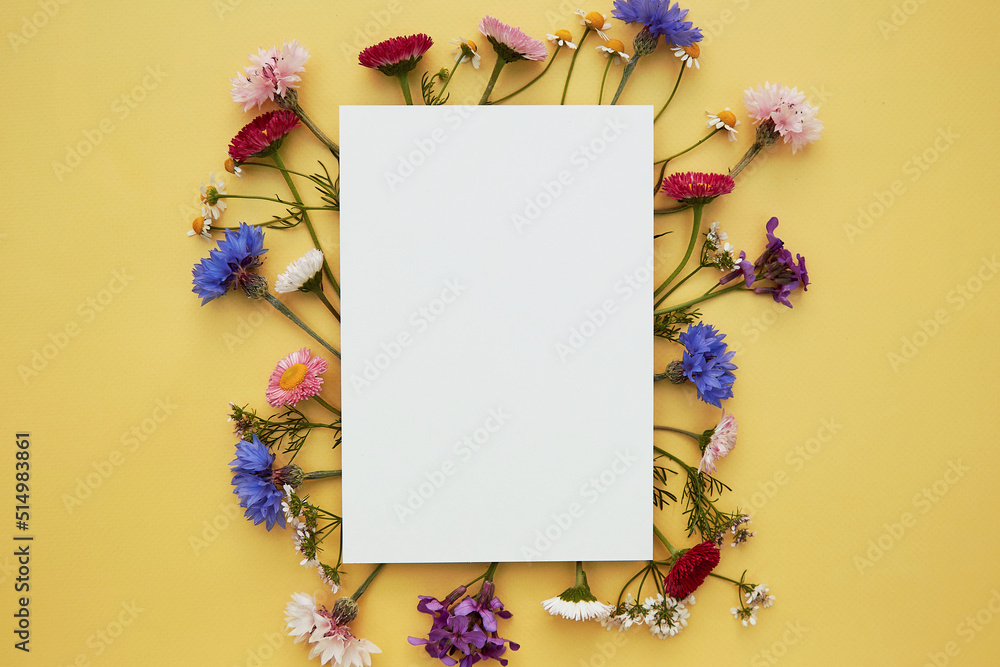 Wishing or invitation mockup stationery card. Birthday, wedding, Mothers day creative card mock up wildflowers flat lay. Place for text. Top view Wishing or invitation mockup stationery card. Birthday, wedding, Mothers day creative card mock up wildflowers flat lay. Place for text. Top view
