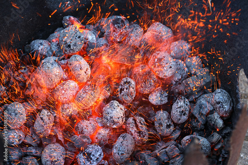 Glimmering heat from glowing charcoal to harden knives