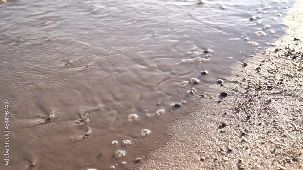 Wave removing word peace from wet sand Wave removing word peace from wet sand