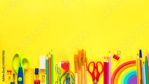 Back to school stop motion .Colorful school and office supplies on yellow background.Copy space.Flat lay