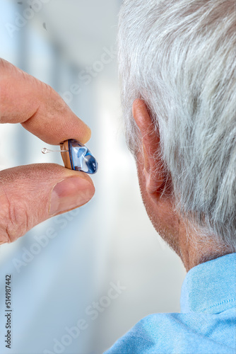 Hearing aid in a senior man photo