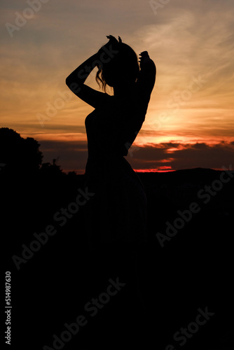 Close up silhouette of dancing woman at sunset.