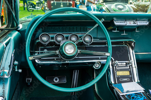 retro car dashboard interior. View of the steering wheel and dashboard of an old vintag car.