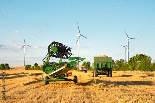 Harvester in a field of cultivated barley in Germany, harvest in the summer, agriculture for food, farmland on the countryside 