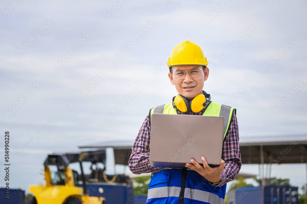 Engineer man with laptop checking and inspect the container, Foreman in hardhat and safety vest checking containers box from cargo Engineer man with laptop checking and inspect the container, Foreman in hardhat and safety vest checking containers box from cargo