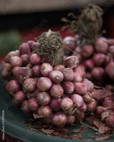 Close up on a bunch of small red onions on a market in Chiang Mai, Thailand