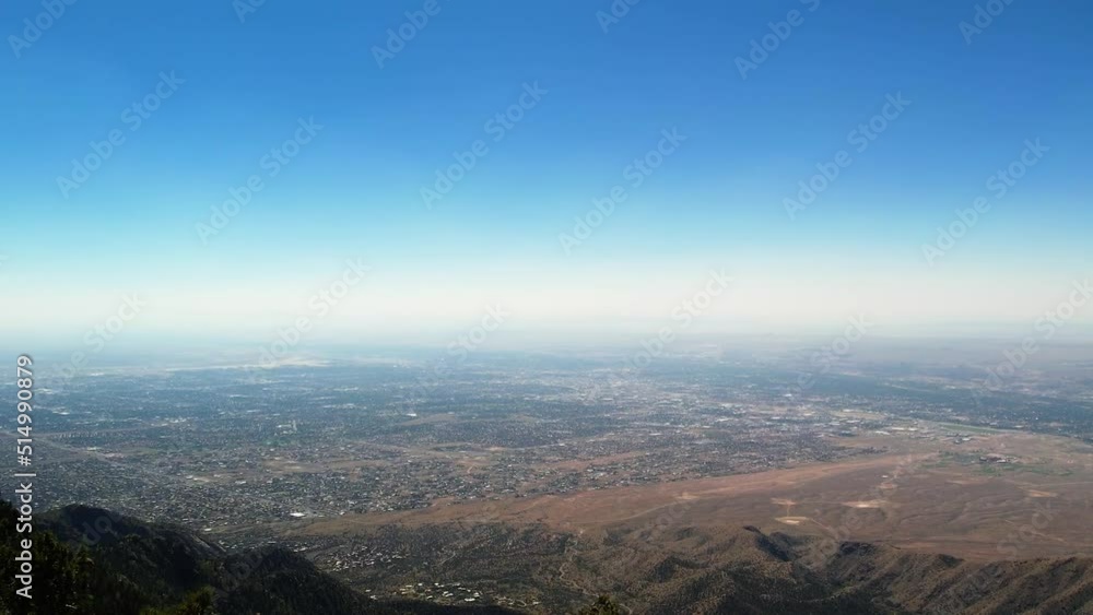 Aerial drone of Albuquerque, New Mexico, over treetops of Sandia Mountains Aerial drone of Albuquerque, New Mexico, over treetops of Sandia Mountains