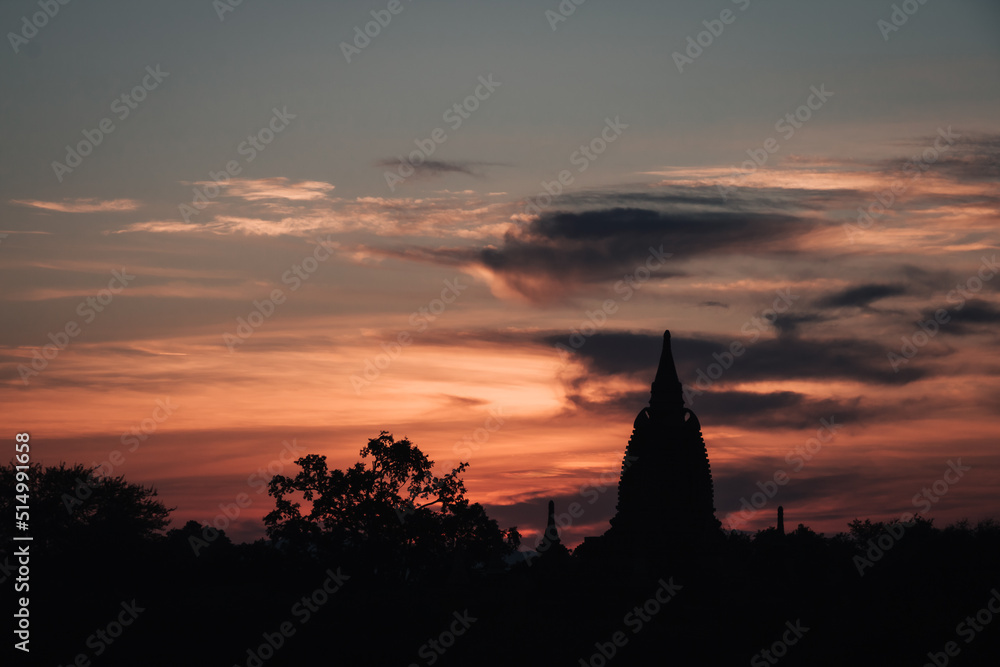 Sunset on a view of a temple ruin in old Bagan, Myanmar with clouds in the colorful sky