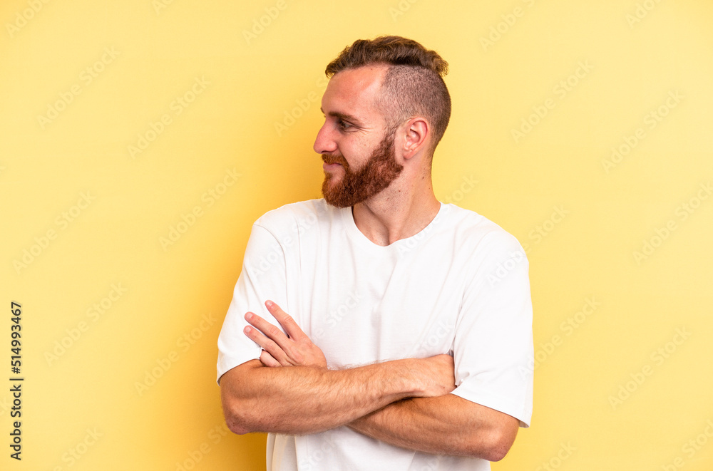 Young caucasian man isolated on yellow background laughing and having fun. Young caucasian man isolated on yellow background laughing and having fun.