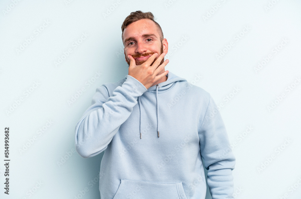 Young caucasian man isolated on blue background doubting between two options. Young caucasian man isolated on blue background doubting between two options.