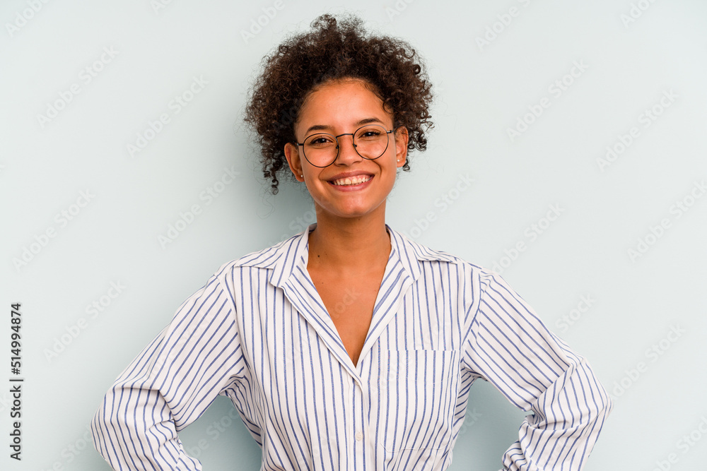 Young Brazilian woman isolated on blue background confident keeping hands on hips. Young Brazilian woman isolated on blue background confident keeping hands on hips.