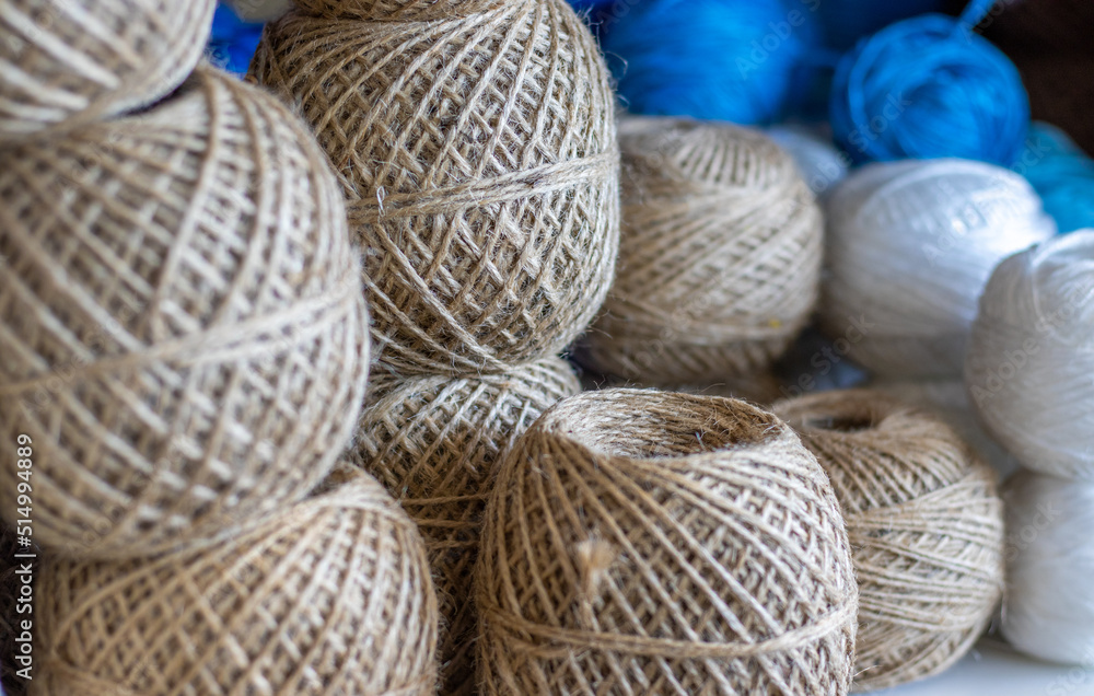 spools of thread on shelf for sale in industrial store,shop,market.jute twine natural twisted rope placed one over another.brown,white and blue colors thread spools.alpaca yarn,cotton,wool factory spools of thread on shelf for sale in industrial store,shop,market.jute twine natural twisted rope placed one over another.brown,white and blue colors thread spools.alpaca yarn,cotton,wool factory