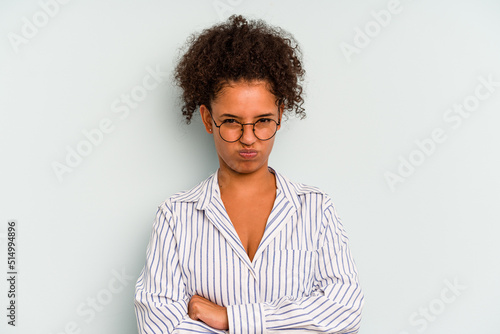 Young Brazilian woman isolated on blue background unhappy looking in camera with sarcastic expression. © Asier