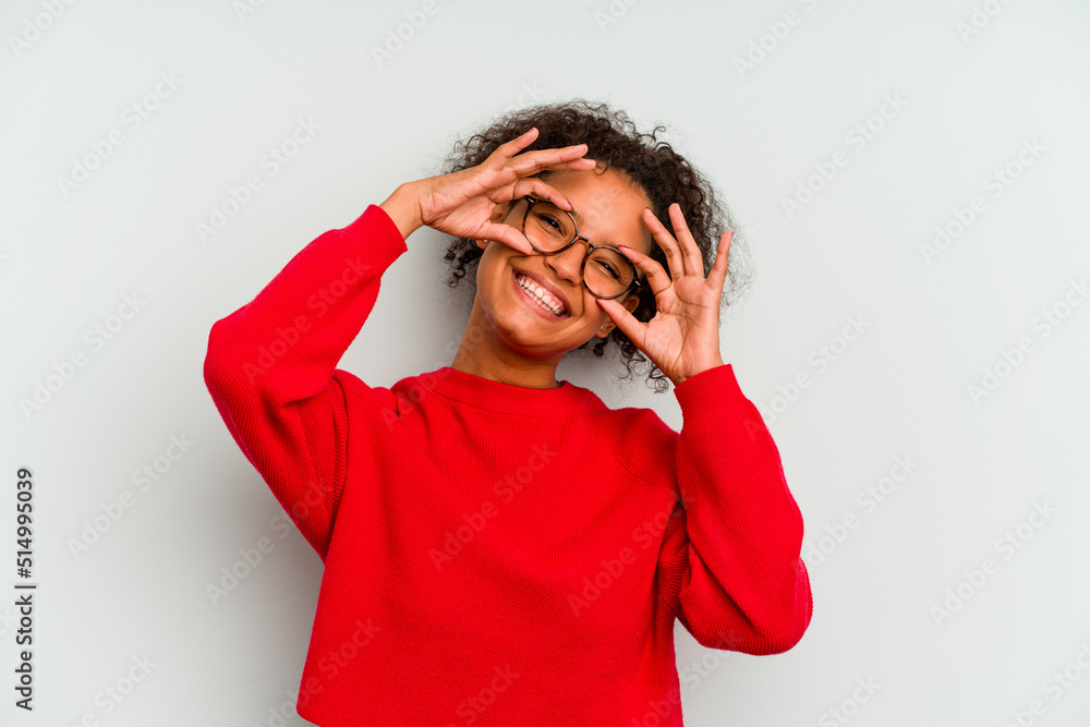 Young Brazilian woman isolated on blue background showing okay sign over eyes Young Brazilian woman isolated on blue background showing okay sign over eyes