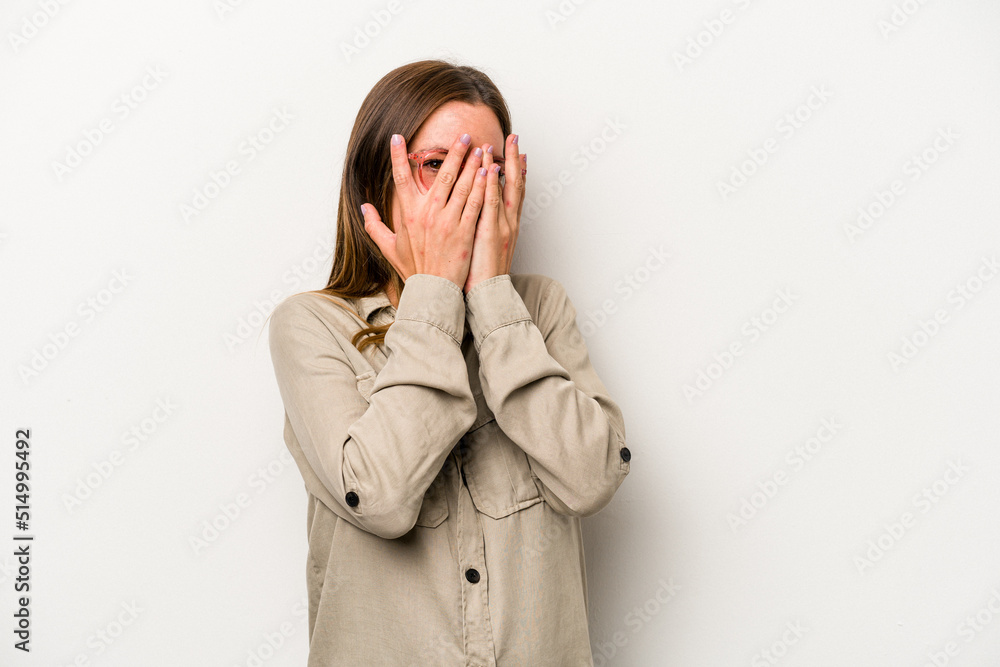 Young caucasian pregnant woman isolated on white background blink at the camera through fingers, embarrassed covering face. Young caucasian pregnant woman isolated on white background blink at the camera through fingers, embarrassed covering face.