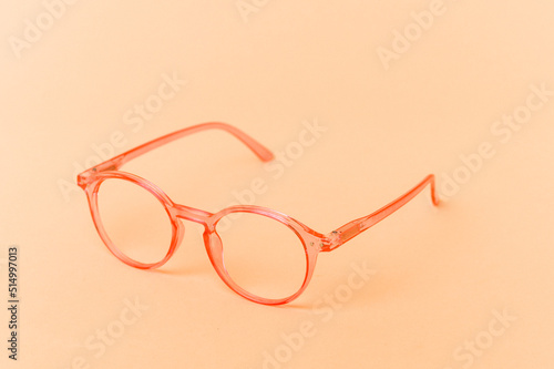 Pink transparent glasses isolated on beige background