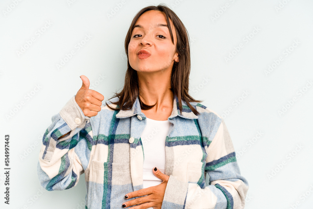 Young hispanic woman isolated on blue background laughing and having fun. Young hispanic woman isolated on blue background laughing and having fun.