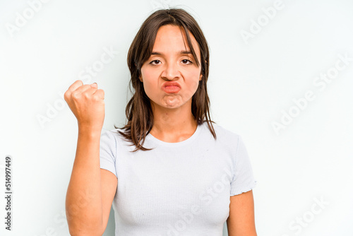 Wallpaper Mural Young hispanic woman isolated on blue background holding something with both hands, product presentation. Torontodigital.ca