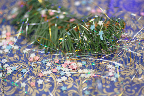 Little colorful stars with a fir branch on a purple background. Christmas, New year , winter holidays concept