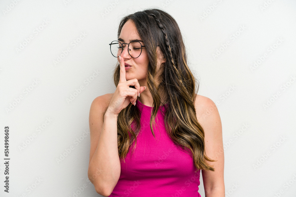 Young caucasian woman isolated on white background keeping a secret or asking for silence. Young caucasian woman isolated on white background keeping a secret or asking for silence.