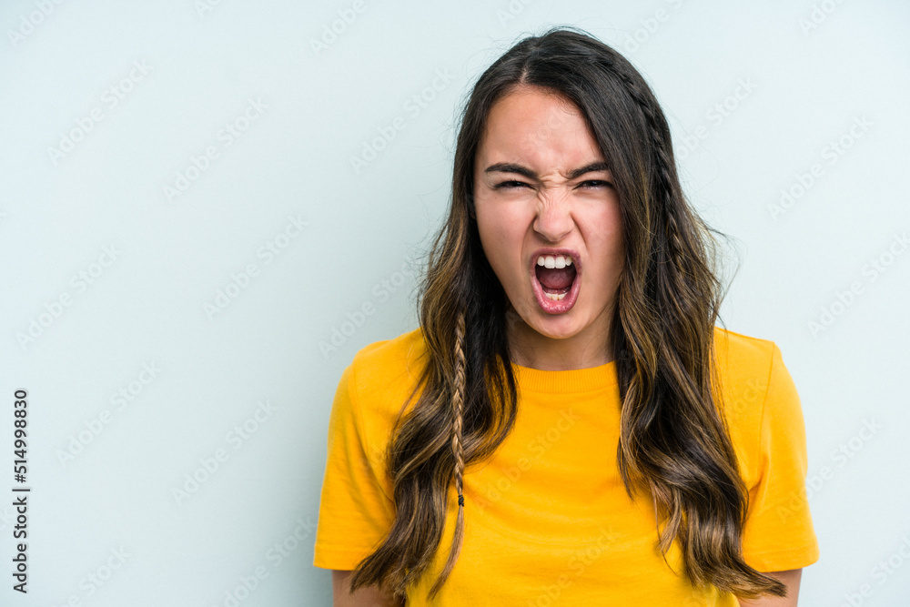 Young caucasian woman isolated on blue background shouting very angry, rage concept, frustrated. Young caucasian woman isolated on blue background shouting very angry, rage concept, frustrated.