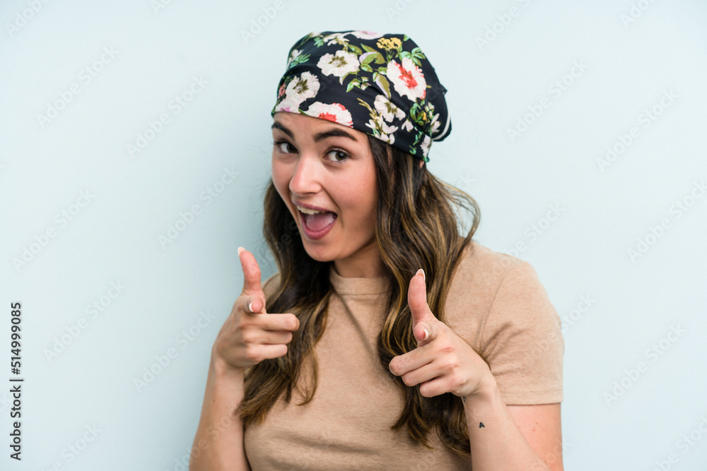 Young caucasian woman isolated on blue background pointing to front with fingers. Young caucasian woman isolated on blue background pointing to front with fingers.