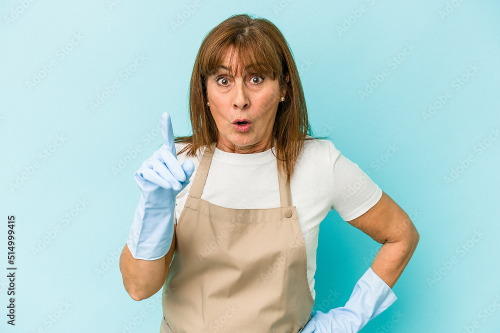 Middle age caucasian woman cleaning home isolated on blue background having an idea, inspiration concept. Middle age caucasian woman cleaning home isolated on blue background having an idea, inspiration concept.