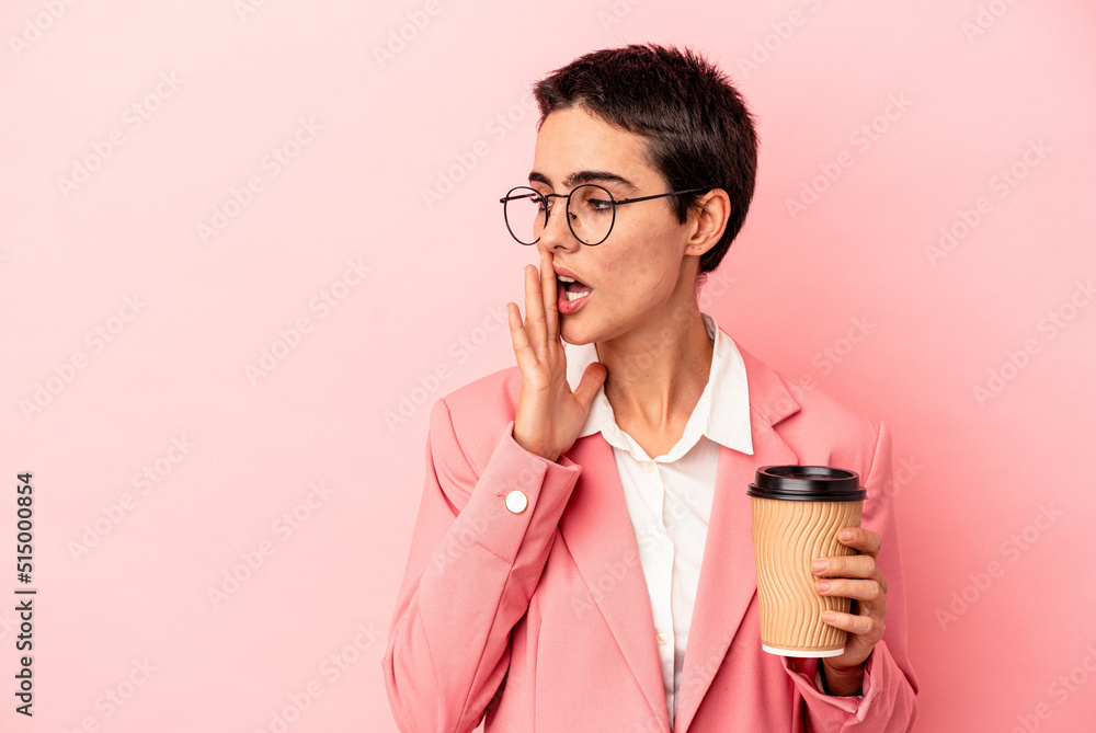 Young caucasian business woman holding a takeaway coffee isolated on pink background is saying a secret hot braking news and looking aside Young caucasian business woman holding a takeaway coffee isolated on pink background is saying a secret hot braking news and looking aside