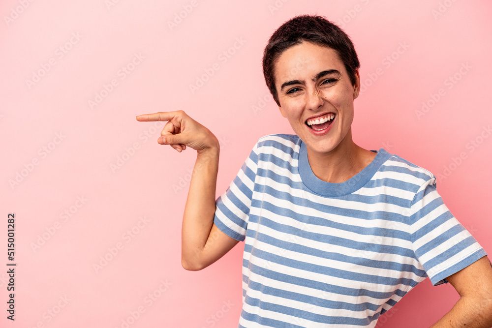 Young caucasian woman isolated on blue background smiling cheerfully pointing with forefinger away. Young caucasian woman isolated on blue background smiling cheerfully pointing with forefinger away.