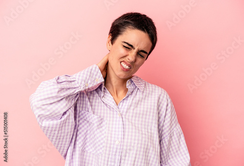 Young caucasian woman isolated on blue background suffering neck pain due to sedentary lifestyle.