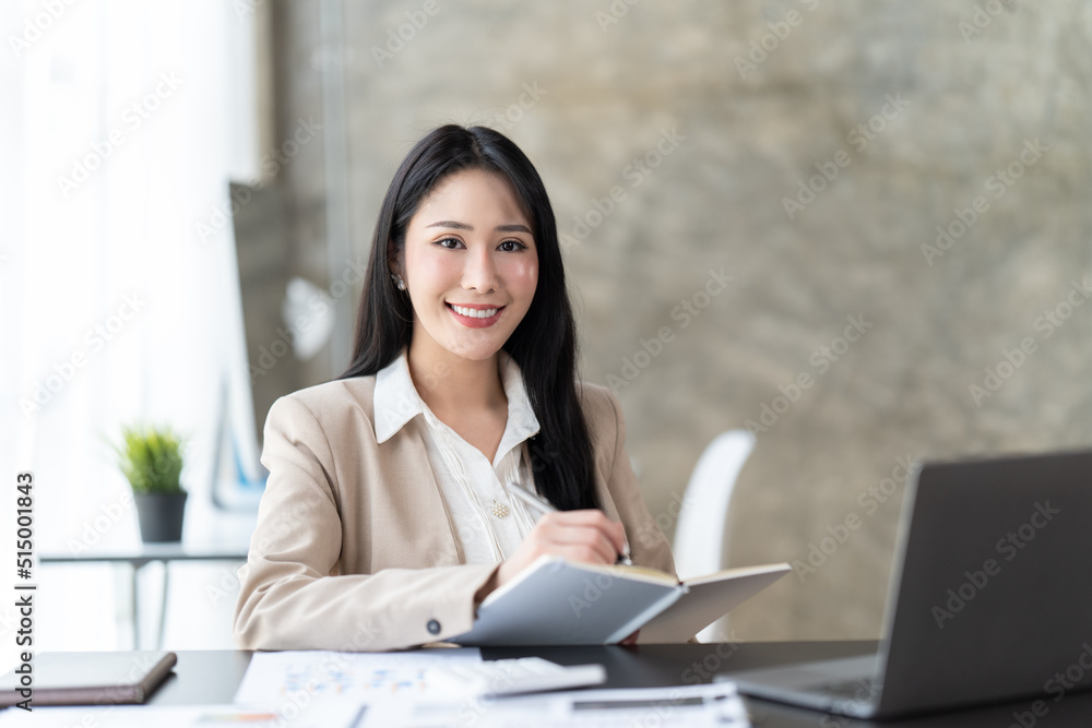 Asian woman working with laptop in her office. business financial concept. Asian woman working with laptop in her office. business financial concept.