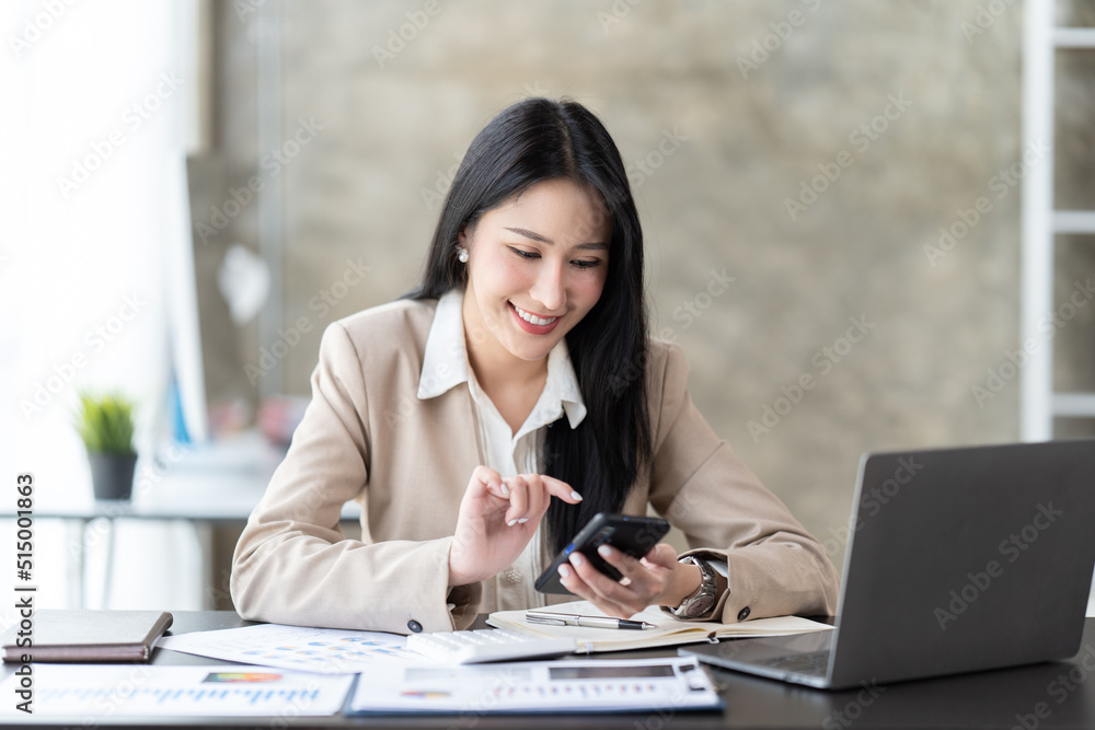 Asian businesswoman in formal suit in office happy and cheerful during using smartphone and working. Asian businesswoman in formal suit in office happy and cheerful during using smartphone and working.
