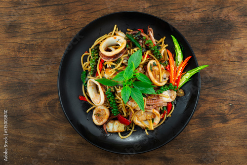 Spaghetti with Squids Stir Fried Spicy Basil Sauce and peppers photo